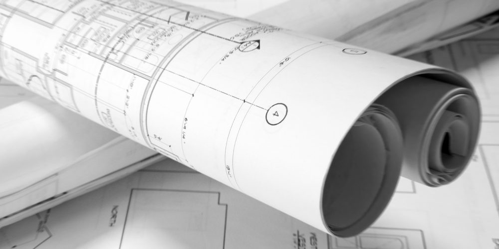 plans roled -up plans on the table
